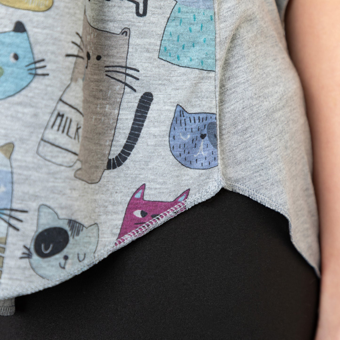 Close up of gray tank top with colorful cat pattern