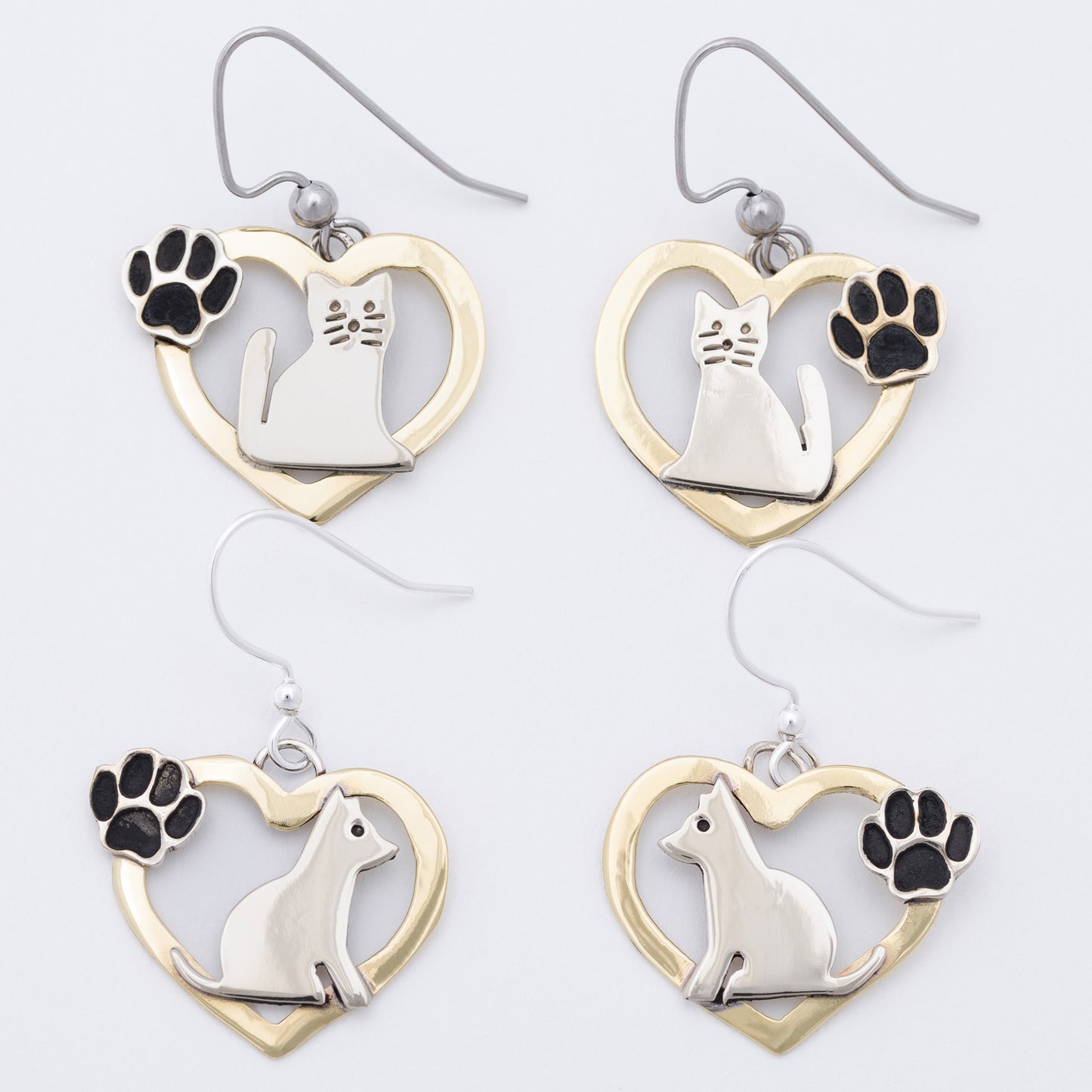 Cat-themed and dog themed earrings with heart designs on a white background