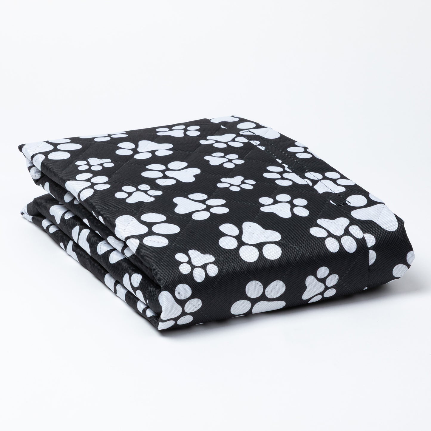 Folded black car seat cover with white paw prints on a white background