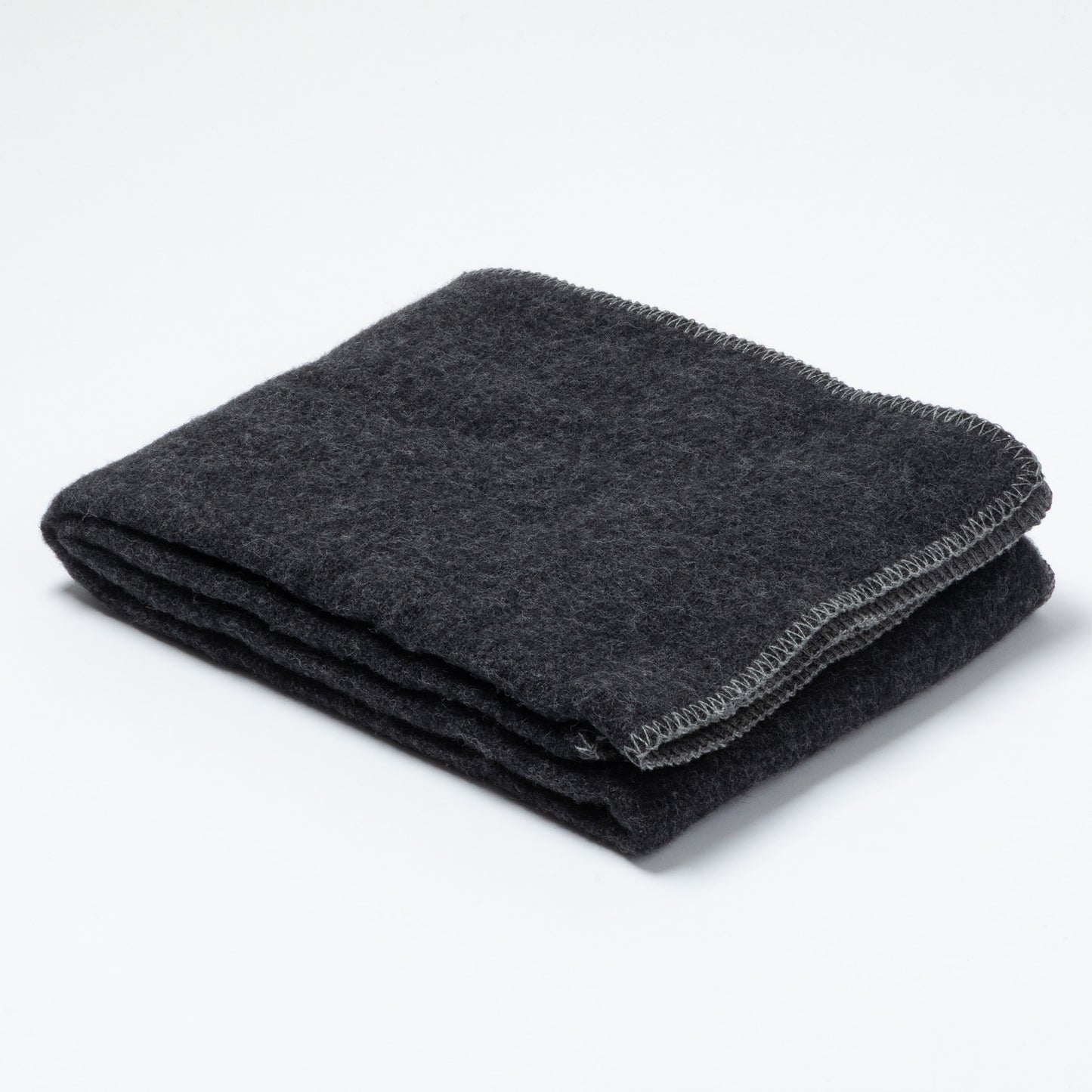 A folded dark charcoal gray wool blanket with a textured surface and a visible stitched border, photographed on a clean white background.