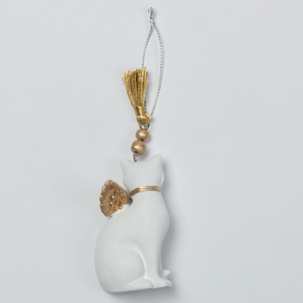 A white cat-shaped ornament with gold accents, including a collar, ear detail, and tassel, hanging from a silver chain against a light gray background.