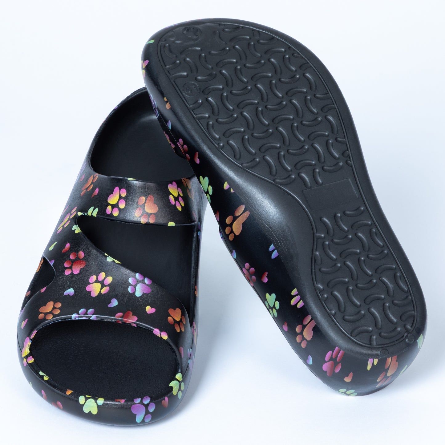 ombre paws with hearts, Black slides with colorful paw prints, with a textured sole on a white background