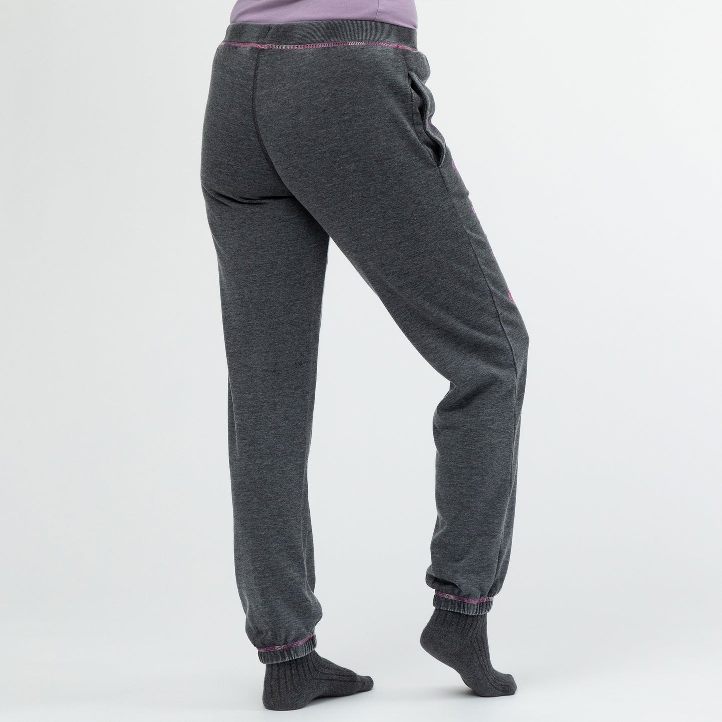 Person wearing gray sweatpants on a white background