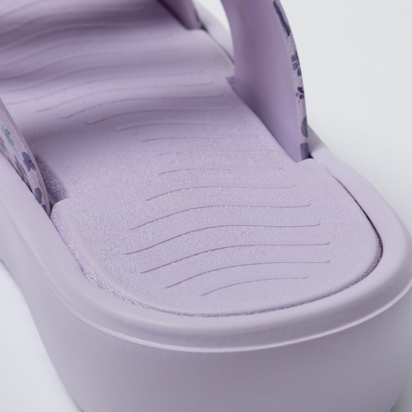 Close-up of a purple footbed with soft texture on a white background