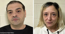 Side-by-side mugshots of a man in a black shirt and a woman in a white hoodie against a light-colored wall.