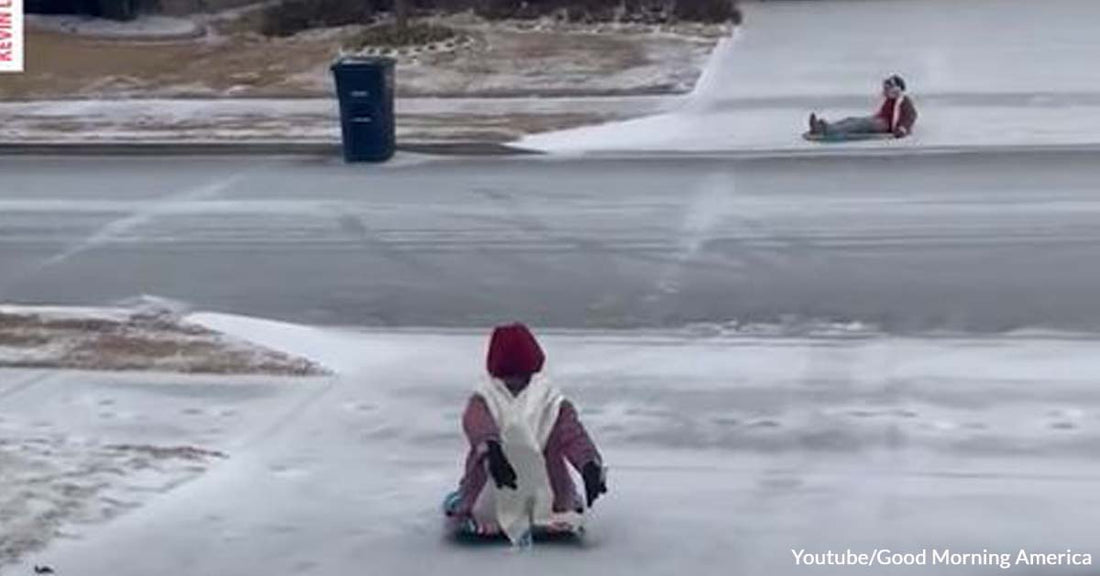 Watch Fun-Loving Young Girls Enjoy Sledding on an Icy Driveway