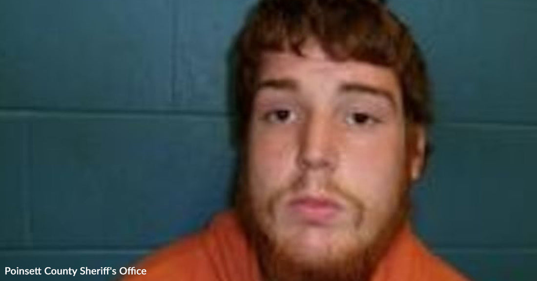 Mugshot of a young man with short reddish hair and beard wearing an orange jail shirt.