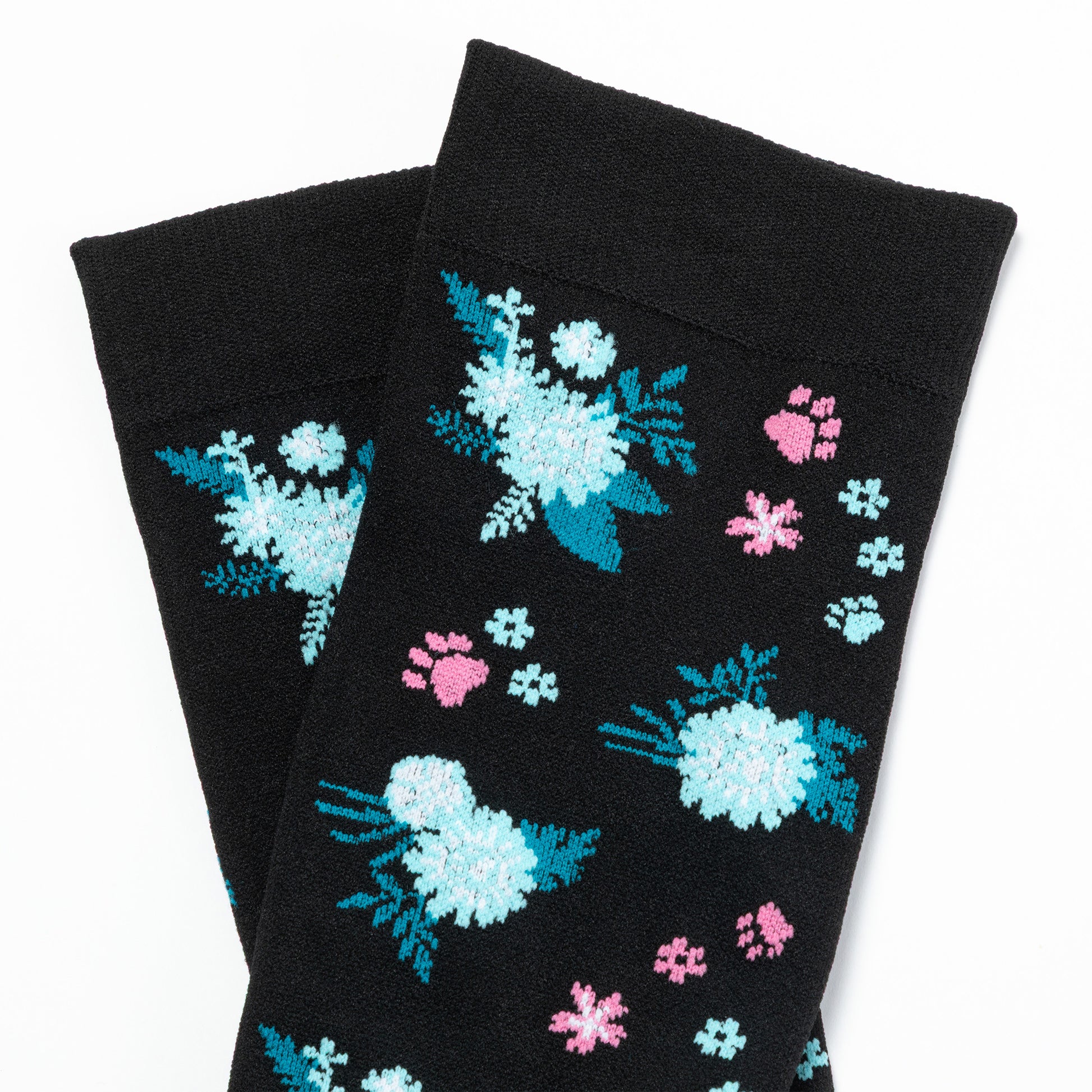 Black compression socks with floral and paw print patterns on a white background