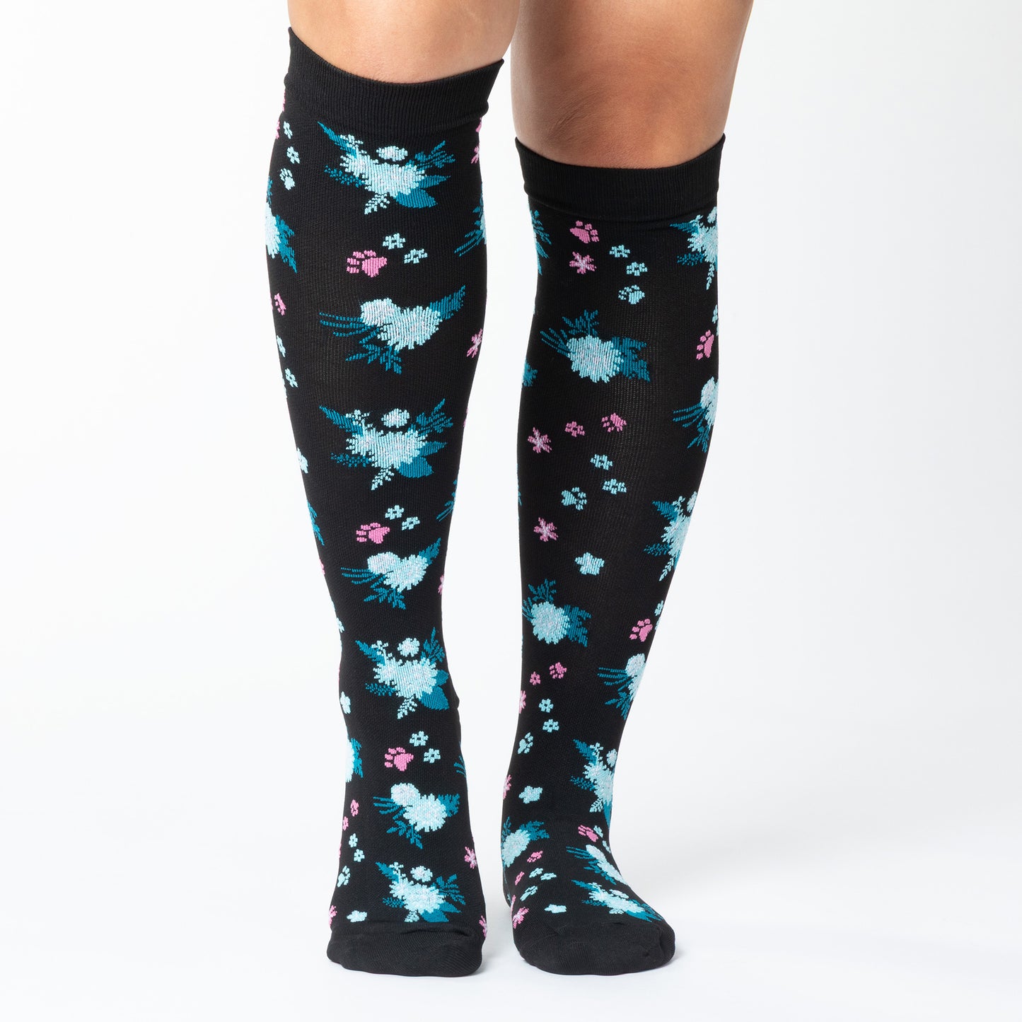 Black knee-high compression socks with paw prints and a floral pattern on a white background.