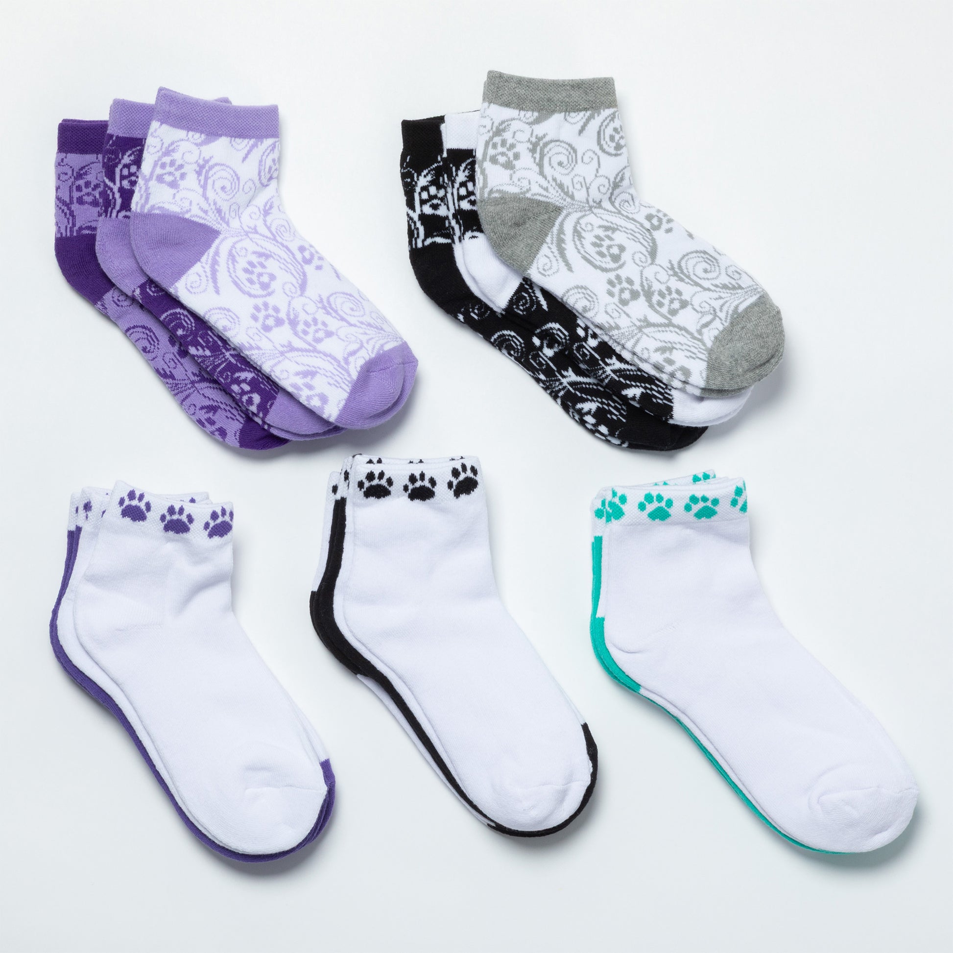 A collection of the different paw print design options included in each set of three ankle-length socks on a white background. 