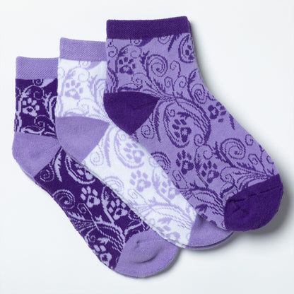 Each design included in the flourish paws purple set of three ankle-length socks.