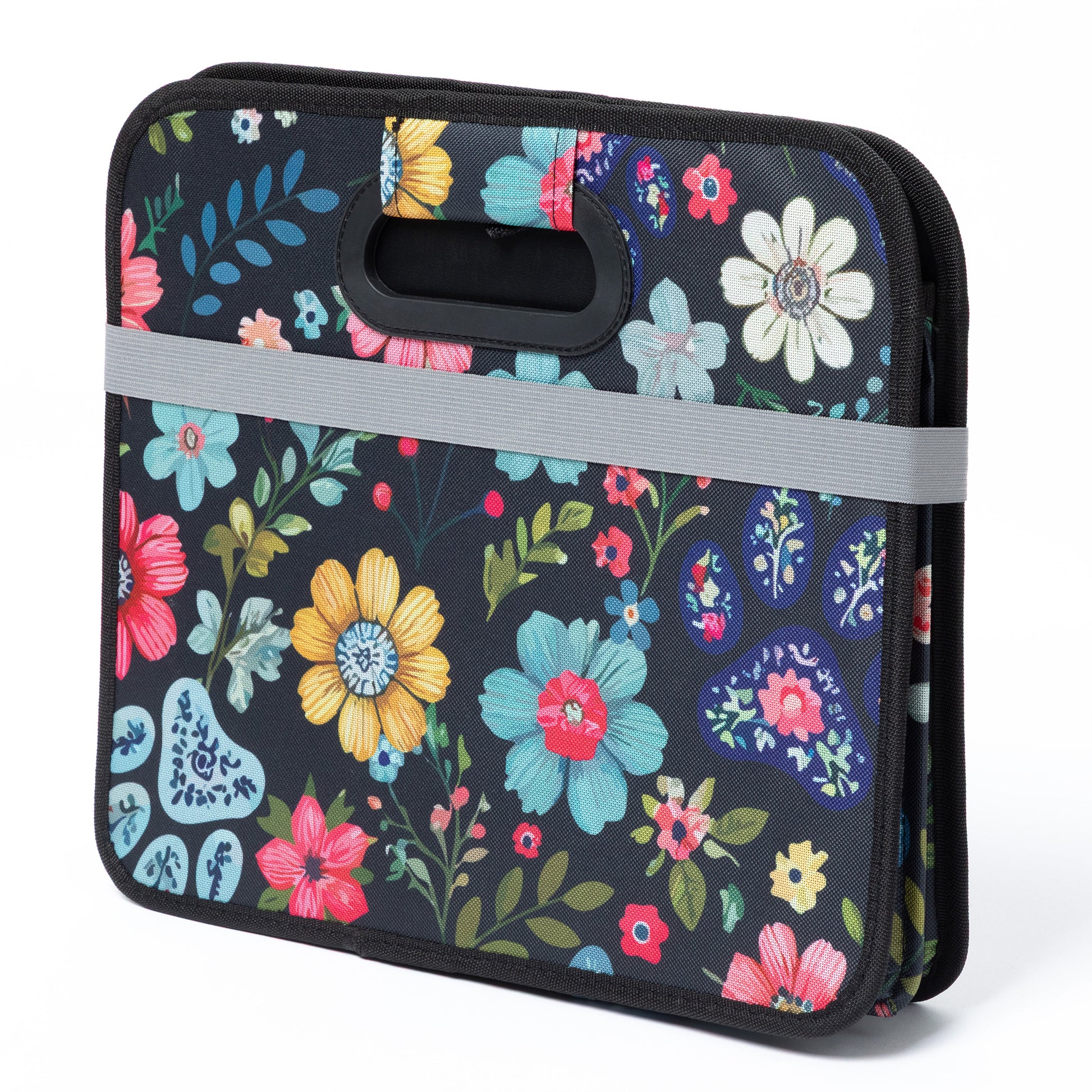 Floral-patterned trunk organizer with a handle on a white background