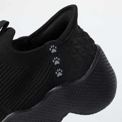 Black shoe with paw print design on a light gray background