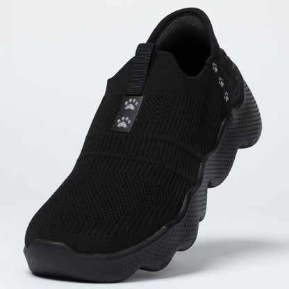 Black slip-on shoe with paw print design on a light gray background