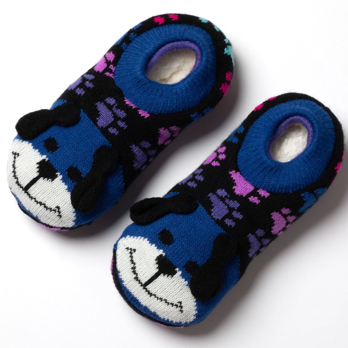 blue and rainbow paw patterned knitted slipper socks with a smiling dog face on top, showing a plush interior rainbow dog