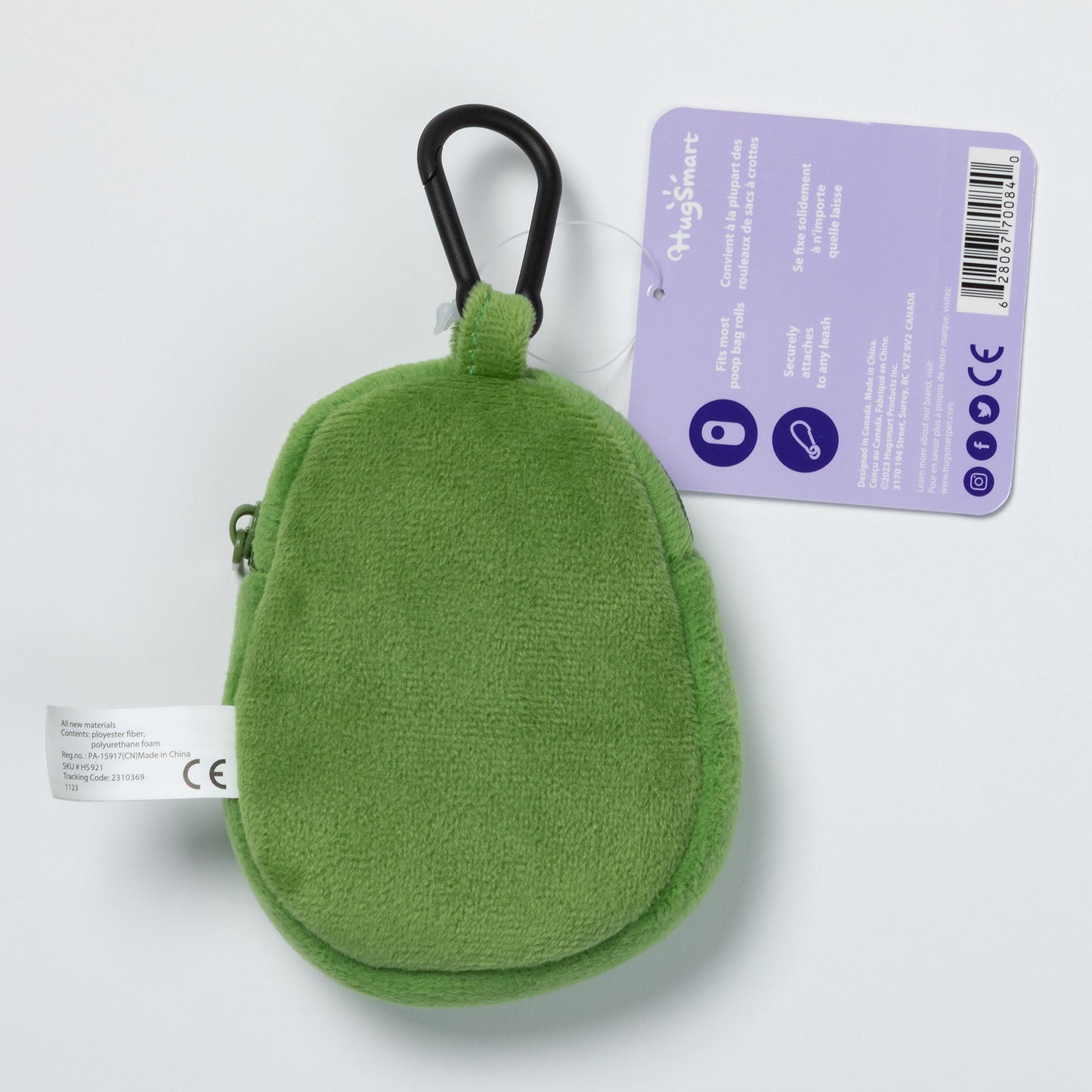 Green plush avocado-shaped keychain with a carabiner for pet waste bags on a light gray background.