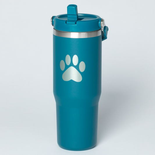 Teal tumbler featuring a silver paw print design on the surface.