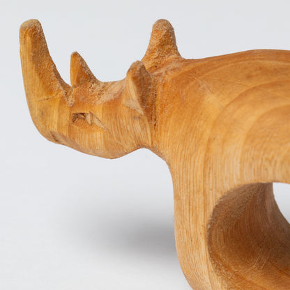 Wooden rhinoceros napkin ring on a white background.