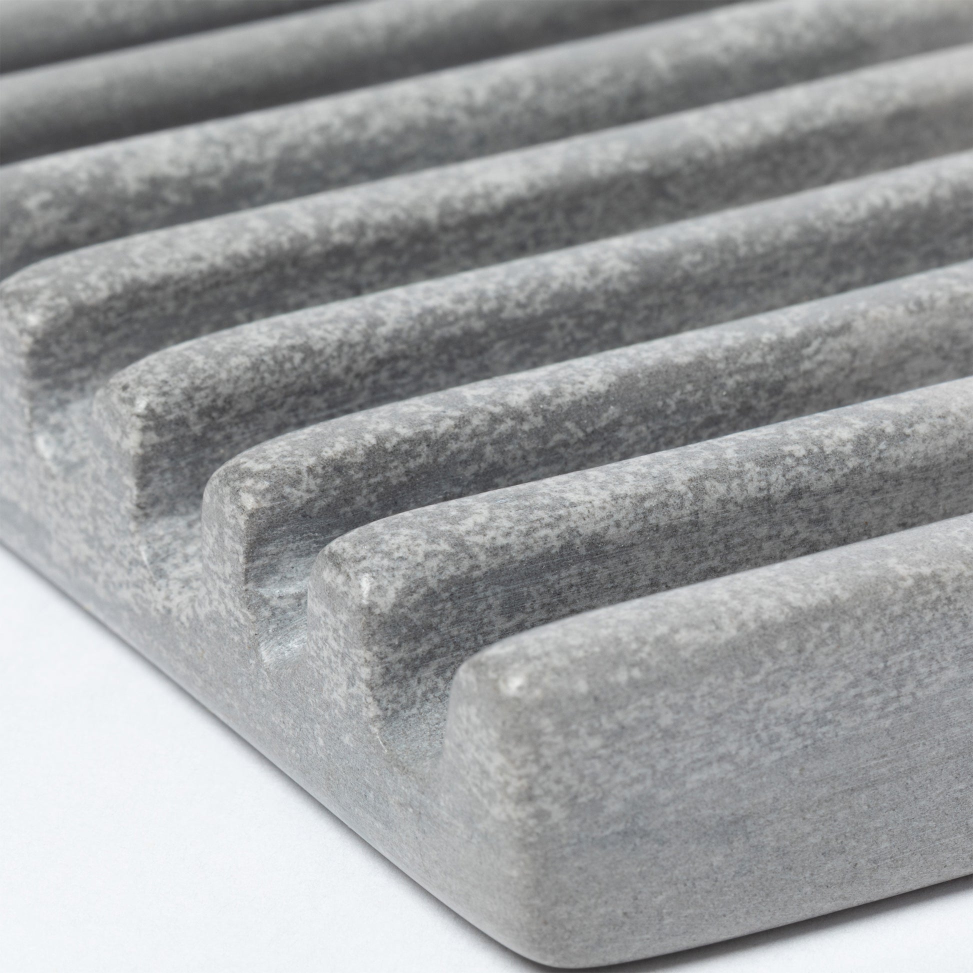 Close up of the ridges on a gray soapstone soap dish.