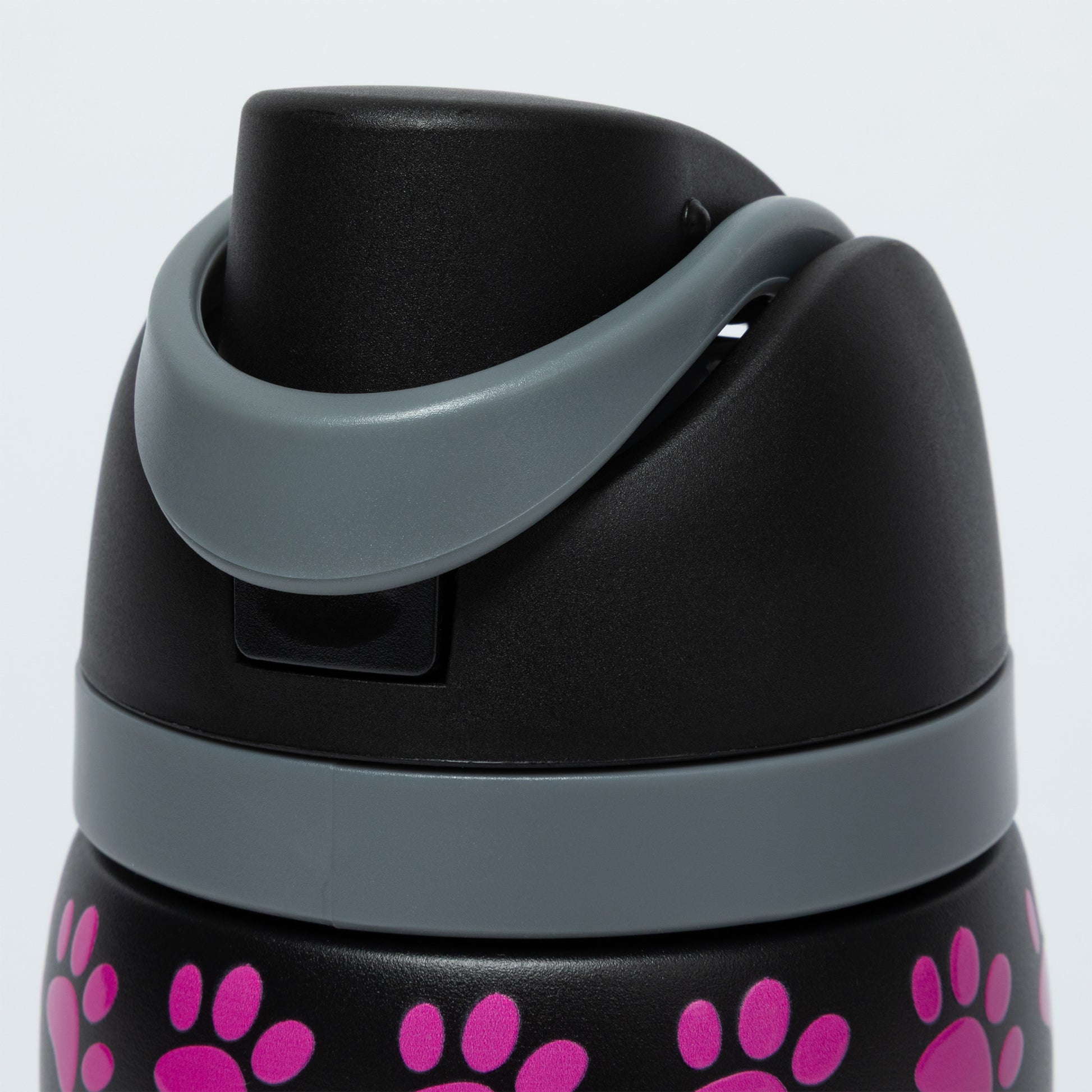 Black water bottle with pink paw prints and gray lid on a white background