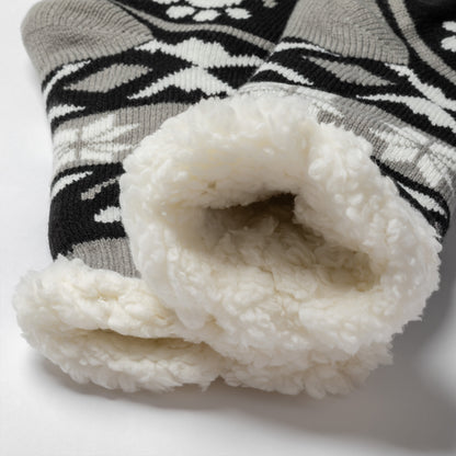 Pair of gray, black white Sherpa Fleece Lined Paw Print Cabin Slipper Socks with sherpa trim on a light gray background alpine fair isle paws black, detail shot of plush interior