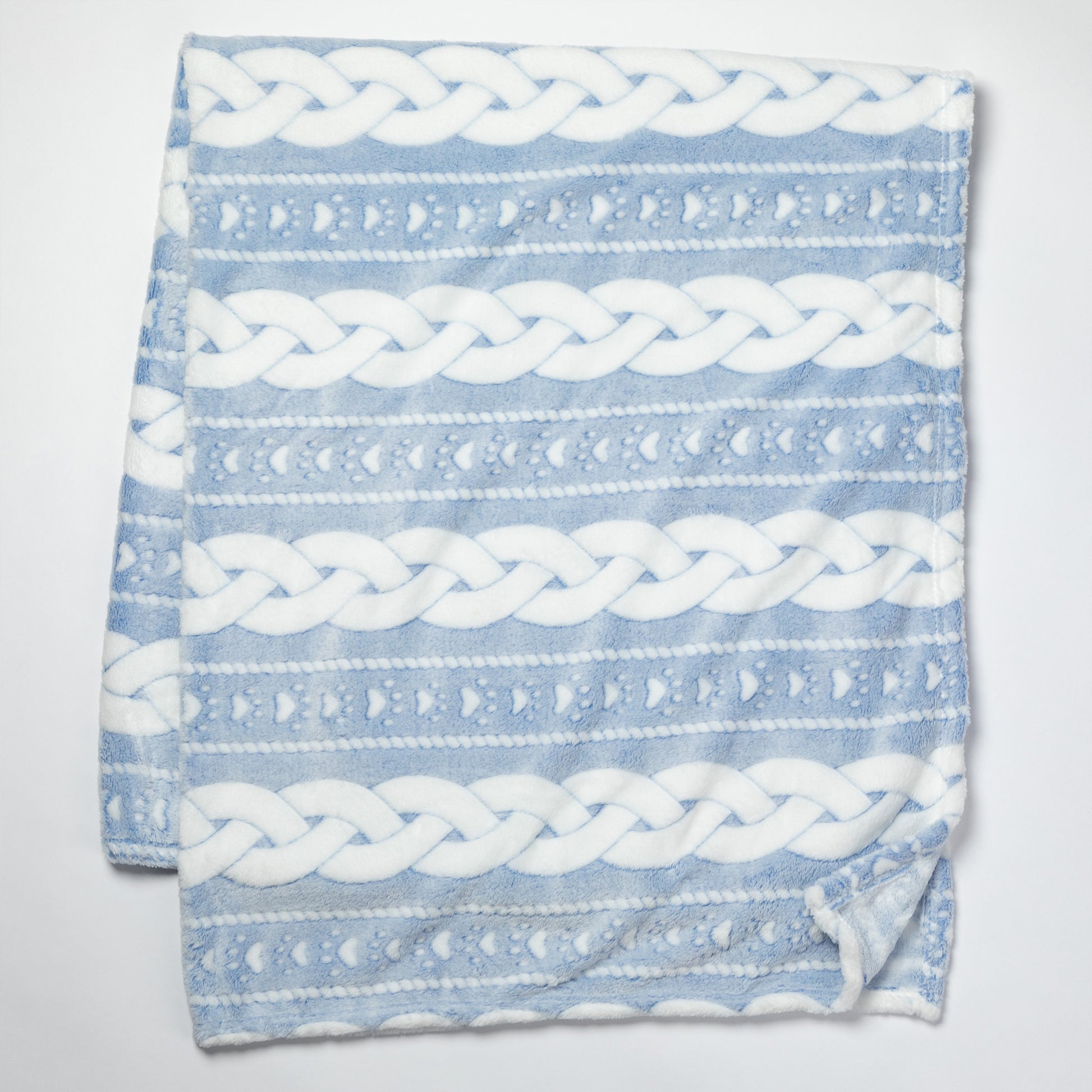 Blue blanket with white braided pattern on a light gray background