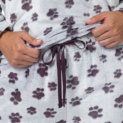 Purple drawstring on the adjustable waistband of the fluffy paw print patterned pajama pants. 