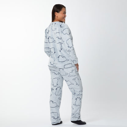 A woman wearing a matching set of fluffy, soft long-sleeve pajamas. The top and pants are light grey and patterned with cute cat outlines. She is showing the back if the long-sleeve top and pants.