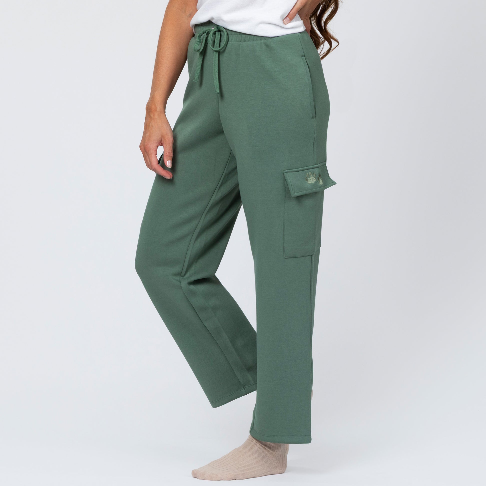 Green cargo pants worn by a person on a white background