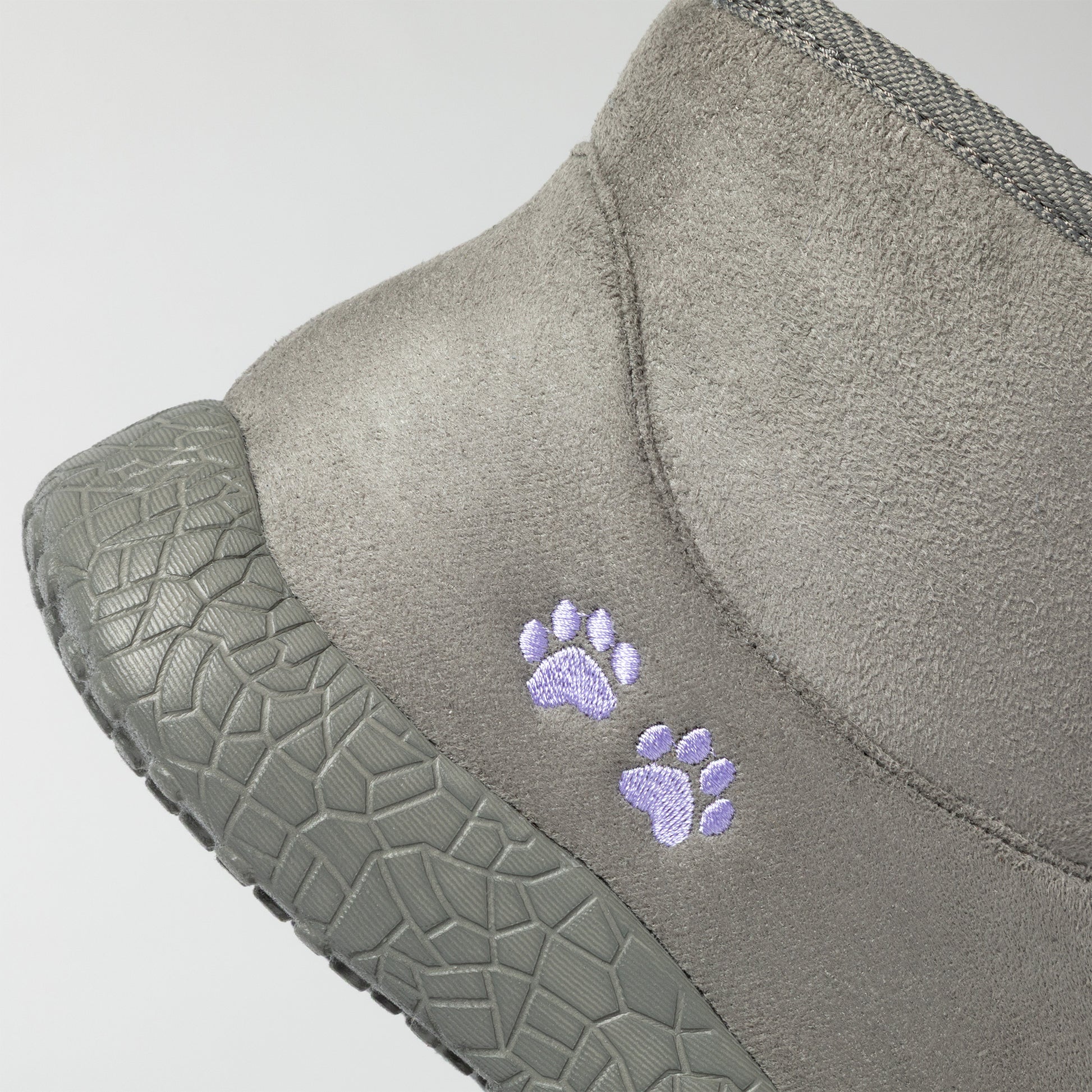 Gray slipper with paw prints on a light gray background
