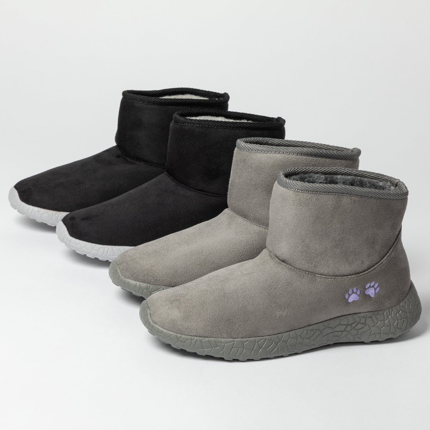 Pair of gray and black ankle boots on a light gray background