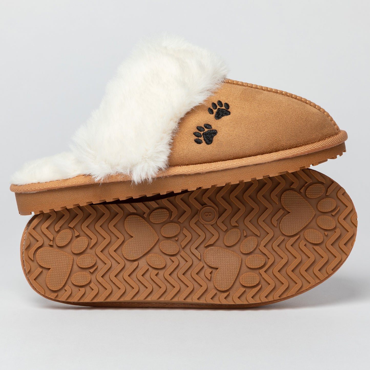 Tan slipper with white fur lining and paw print design on a light gray background