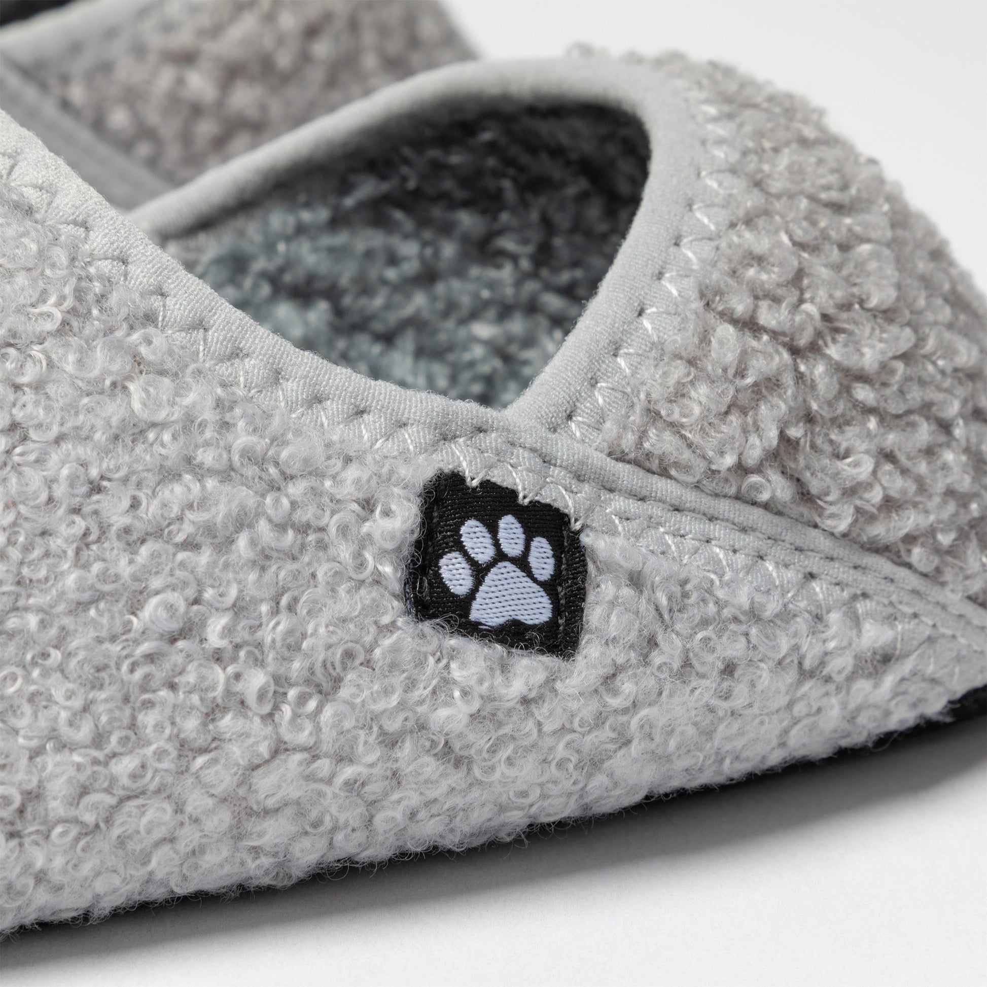 Gray slipper with a paw print design on a white background