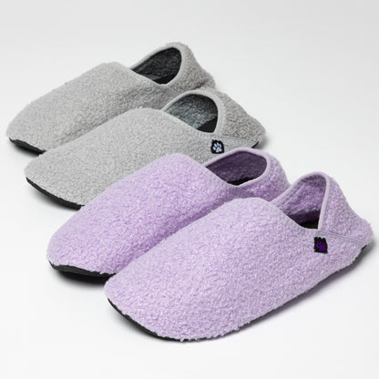 Gray and purple slippers on a light gray background