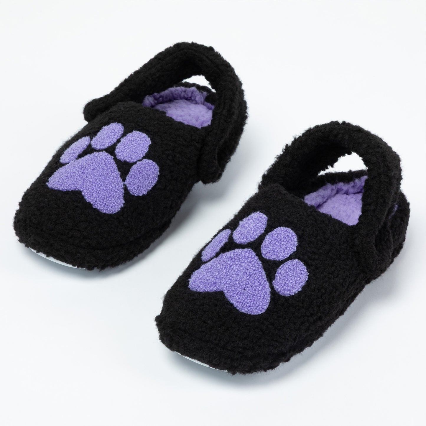 Pair of black fuzzy slippers with purple paw prints on a white background