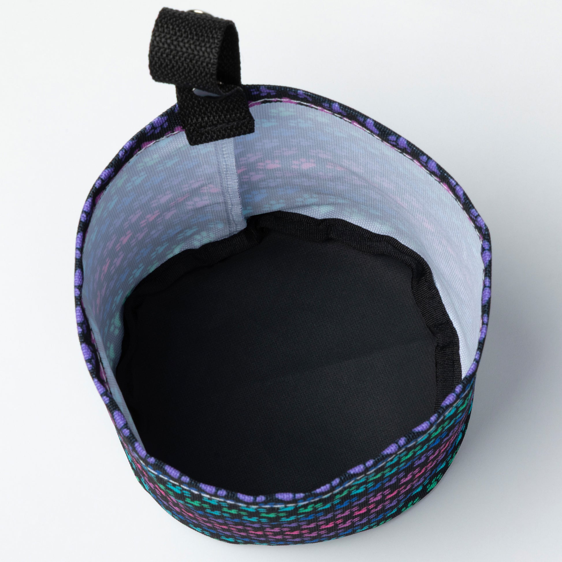 Car garbage holder cover with rainbow paw pattern. Inside of fabric is white and the bottom is black. 