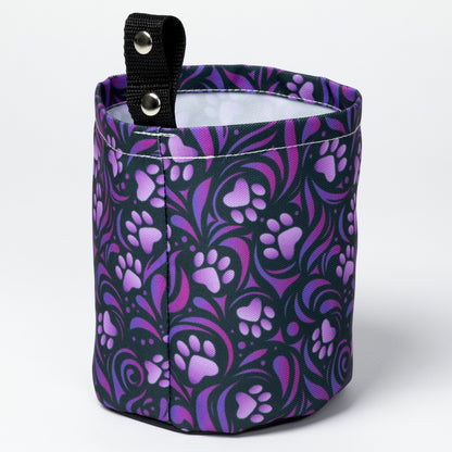 Collapsible car garbage holder with purple paw print pattern on a white background.