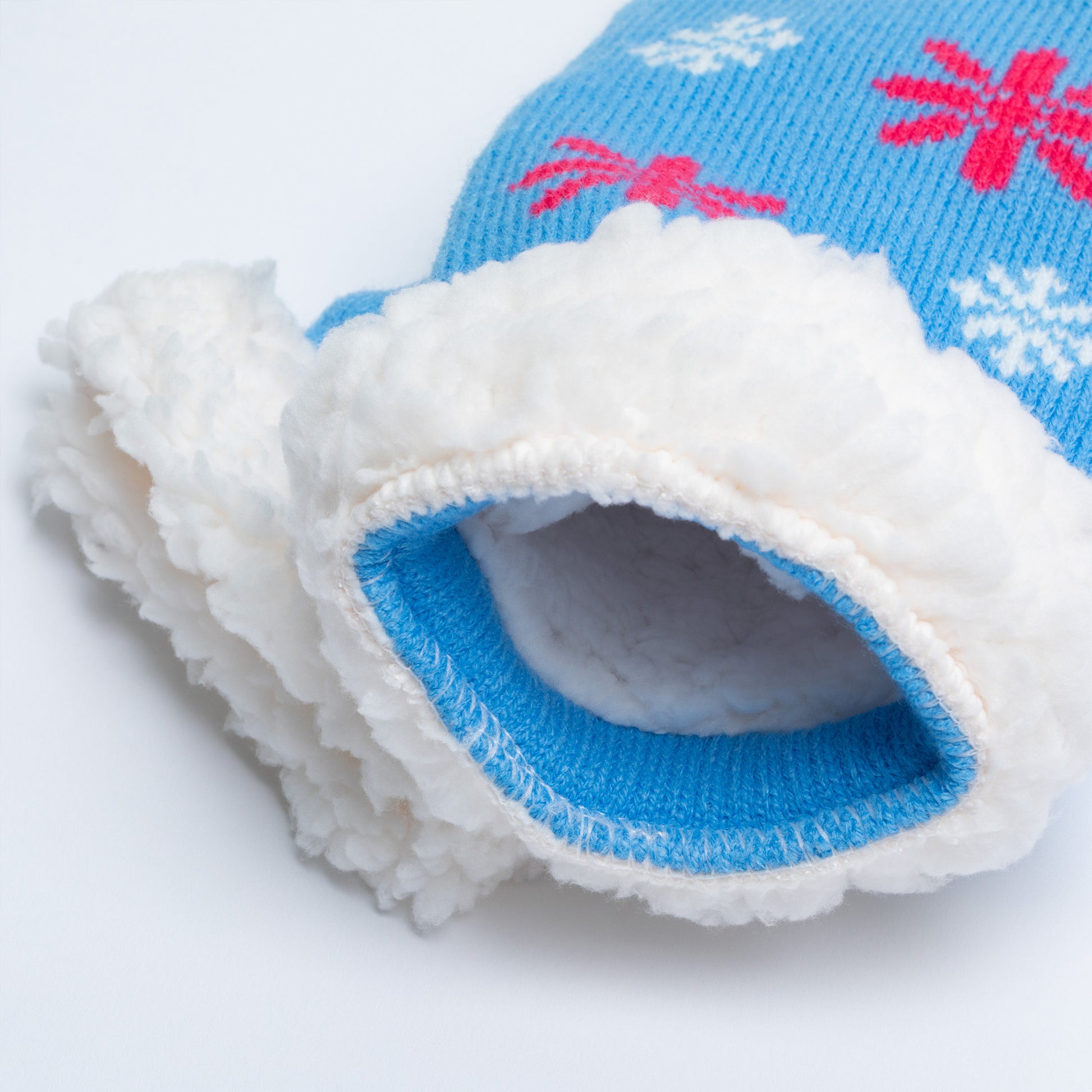 Close up of slipper socks with blue and white design on a white background