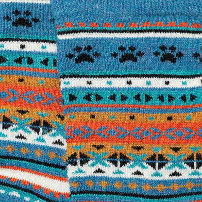Close-up of colorful knitted fabric with geometric pattern and paw prints