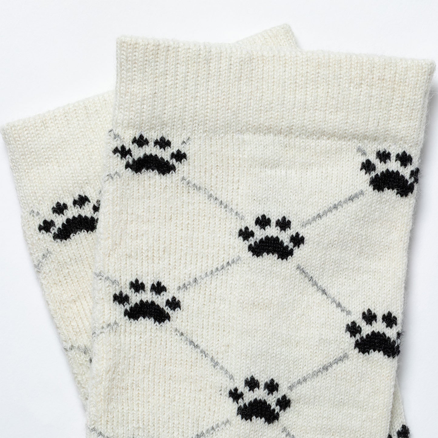 White socks with black paw print pattern on a white background