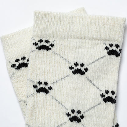 White socks with black paw print pattern on a white background