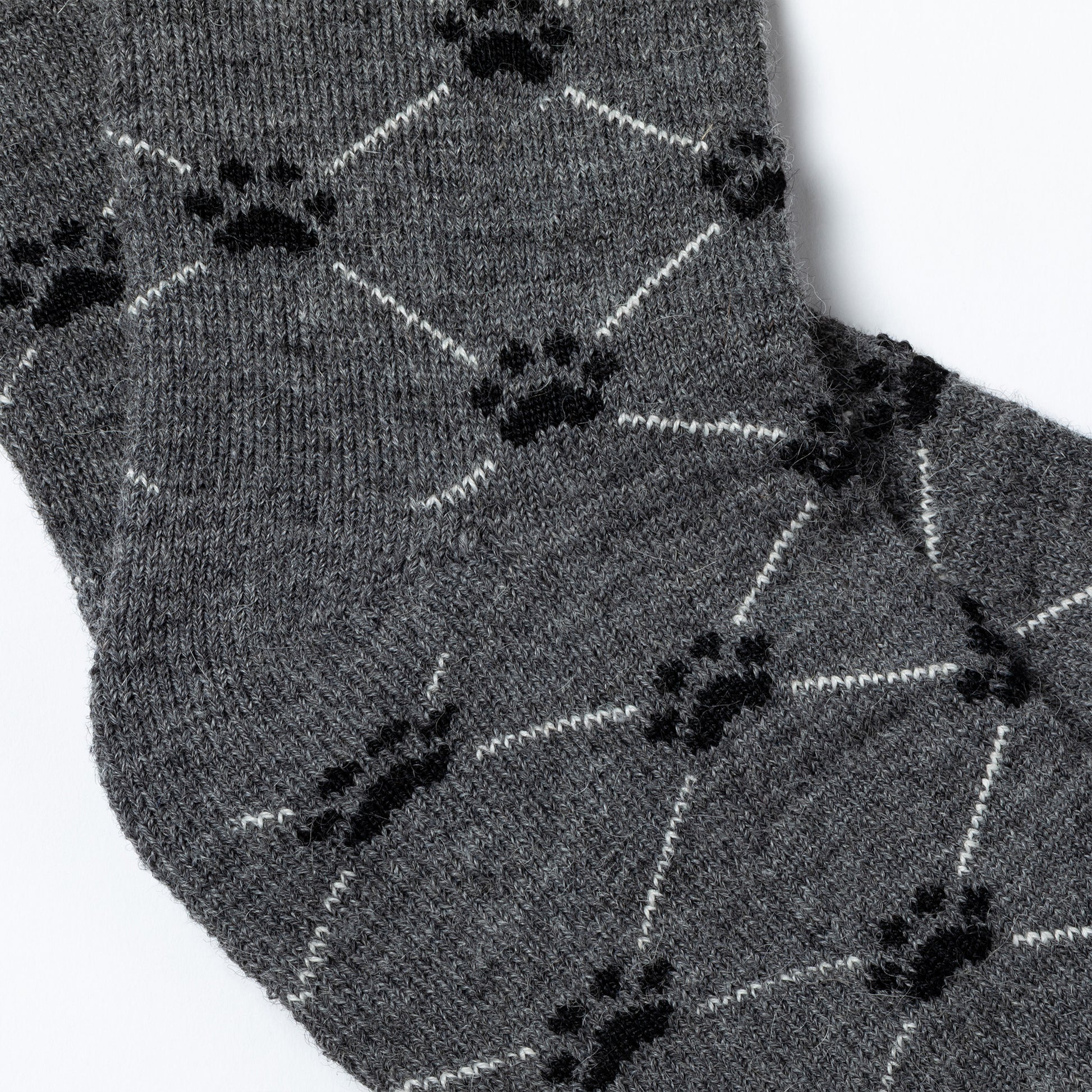 Gray socks with black paw print pattern on a white background