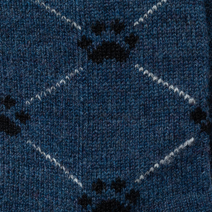 Close-up of blue fabric with black paw prints and white zigzag lines