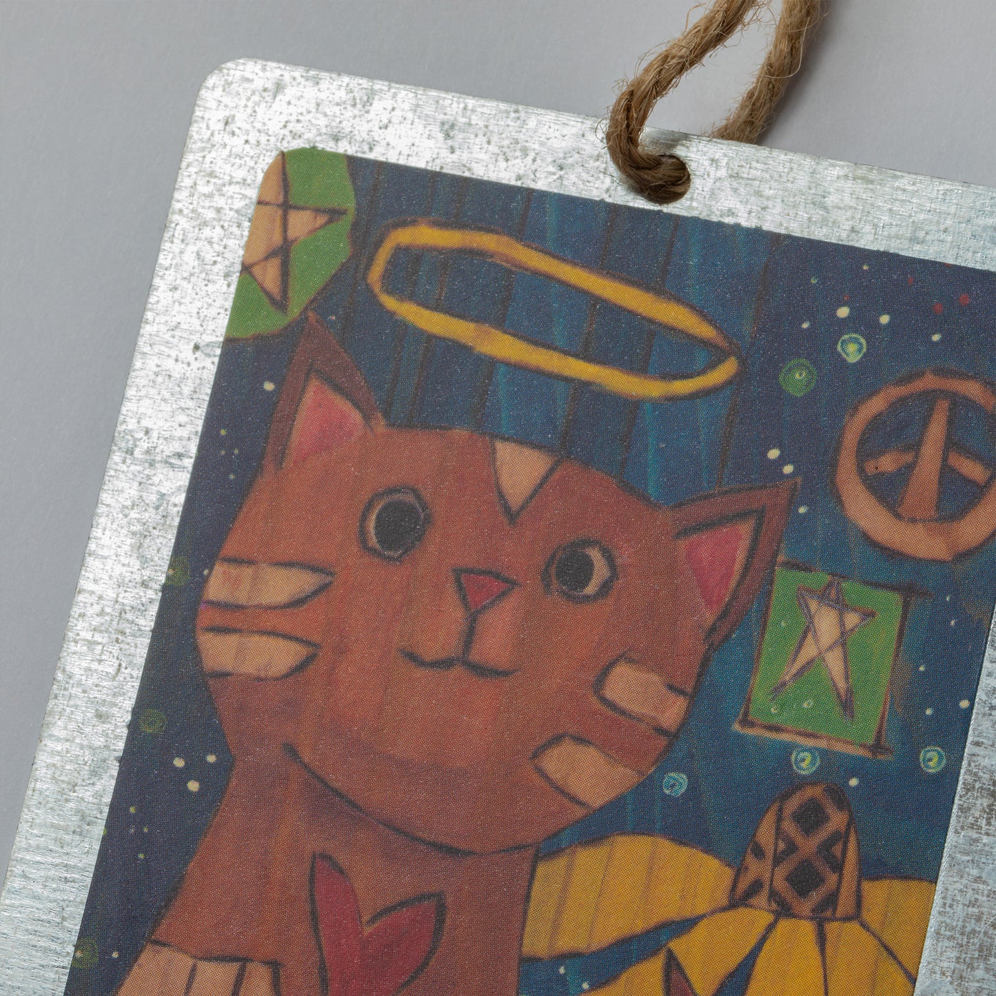 Decorative hanging ornament with a cat illustration, with a peace sign, flower and stars in the back