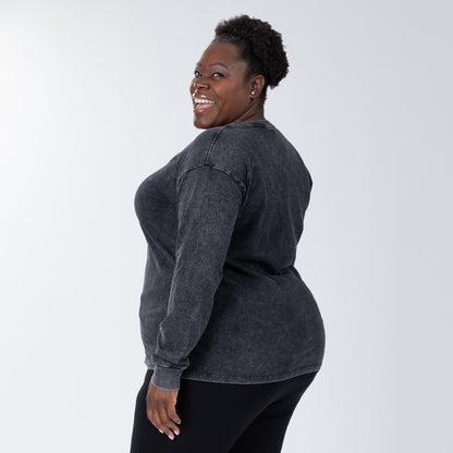 Woman wearing a dark gray long-sleeve shirt on a white background