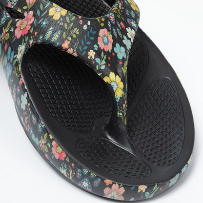 Floral-patterned sandal with black sole on a white background