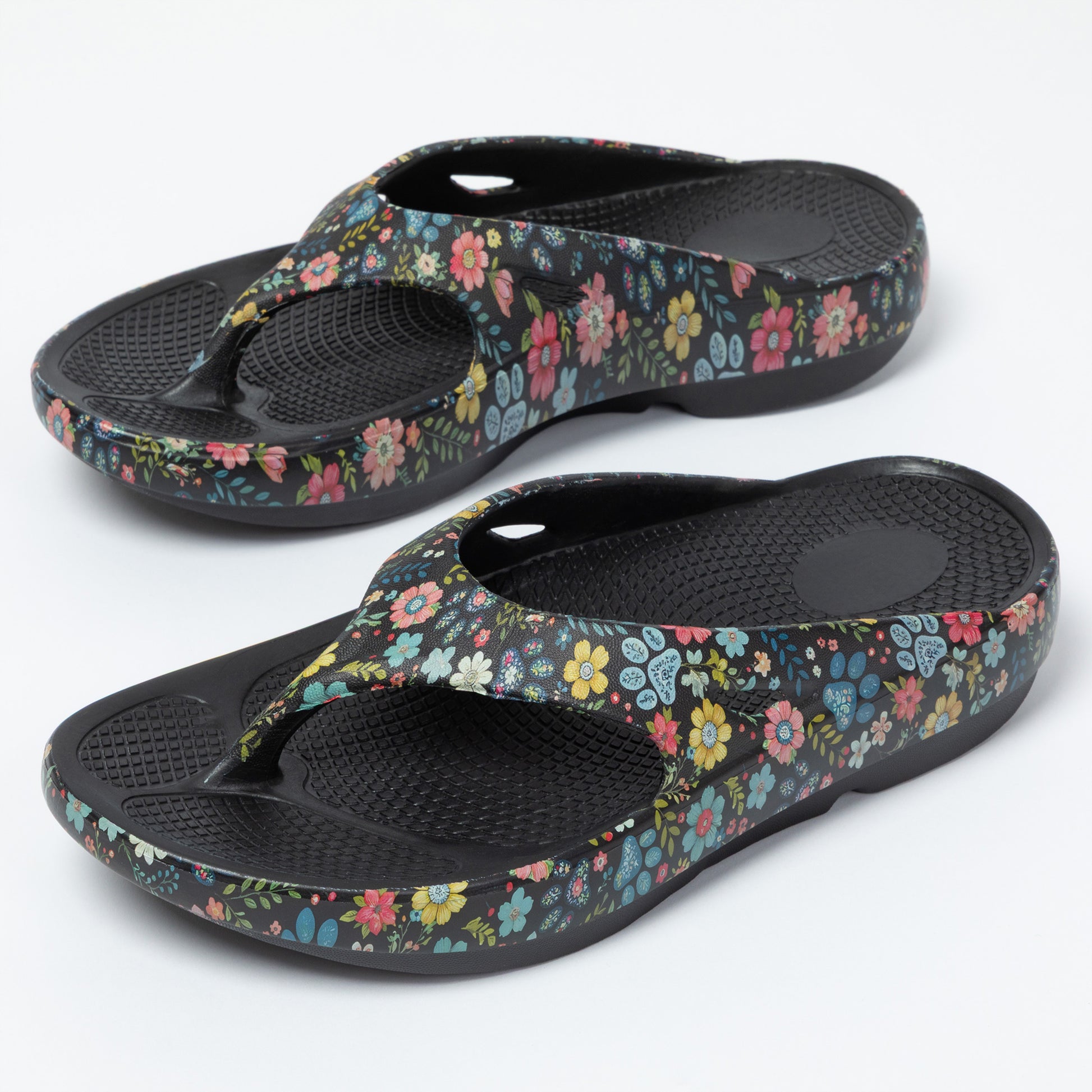 Pair of floral-patterned sandals on a white background