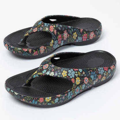 Pair of floral-patterned sandals on a white background