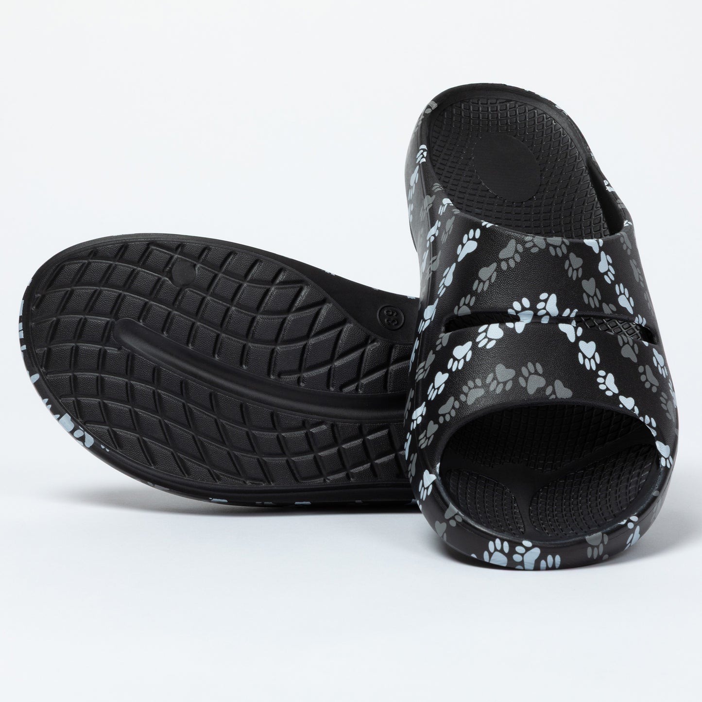 Black slides with paw print pattern on a white background