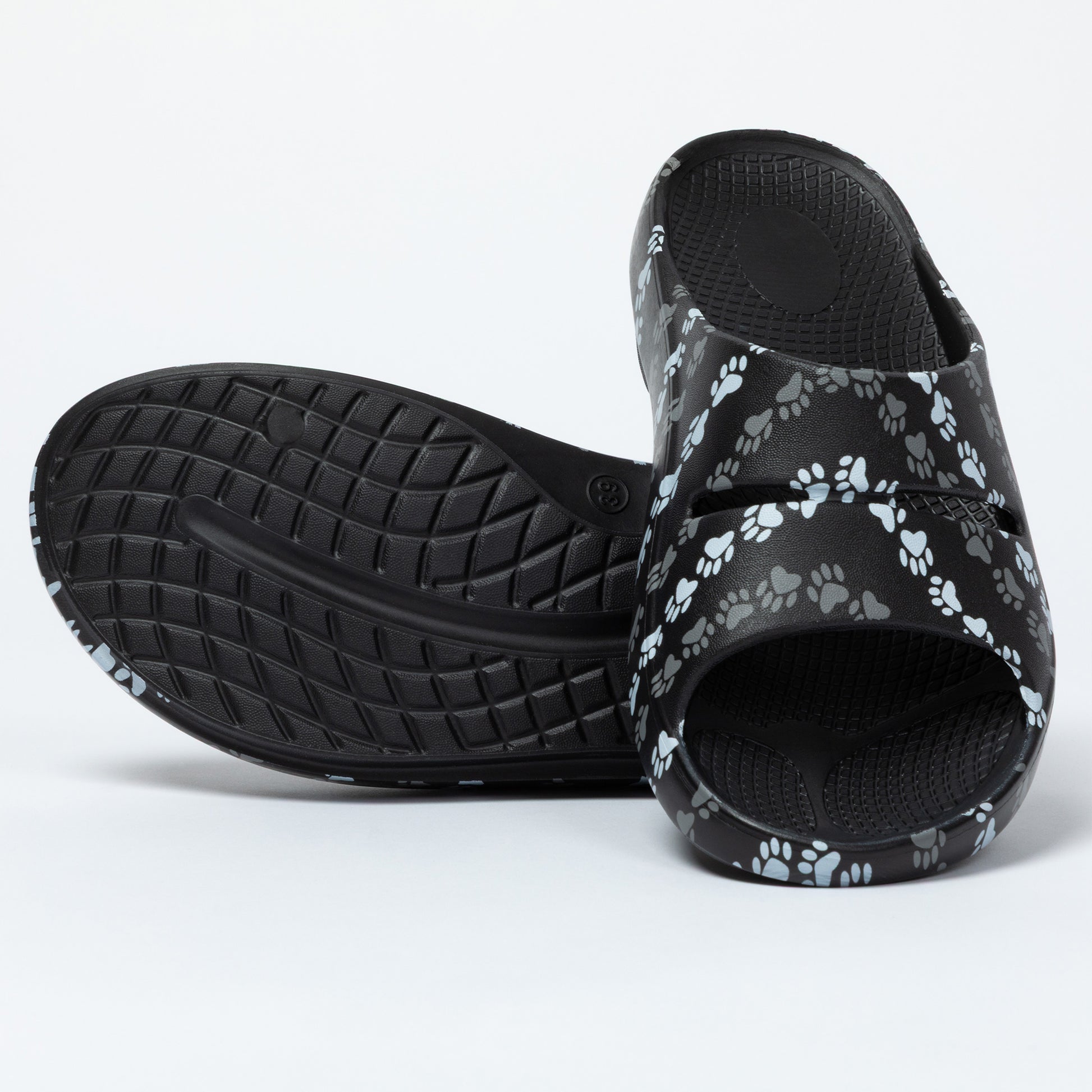 Black slides with paw print pattern on a white background